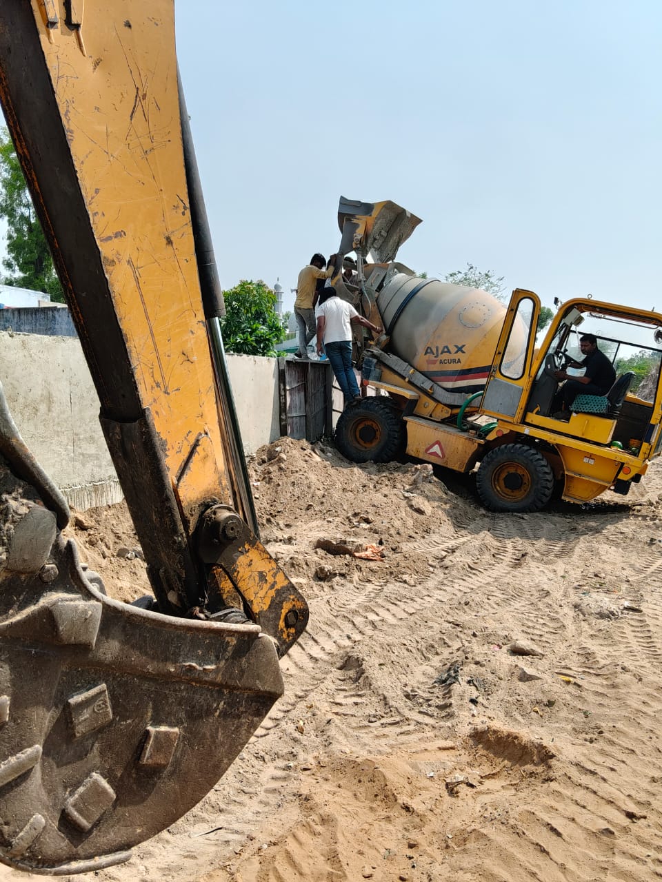 Construction machinery and concrete mixer working at a JLF project site